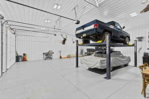 Garage featuring metal wall and a garage door opener