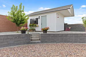 View of outbuilding with a fenced backyard
