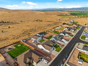 Aerial view of property's location with nearby suburban area and a mountain backdrop