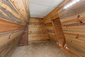 Detailed view of wooden walls, carpet flooring, and a drop ceiling