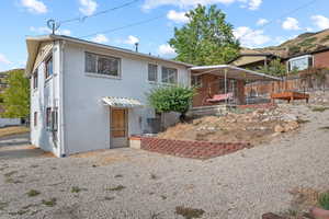 Rear view of property featuring brick siding