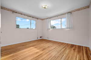 Spare room with light wood-style floors and baseboards