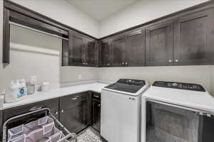 Washroom featuring cabinet space and washing machine and dryer