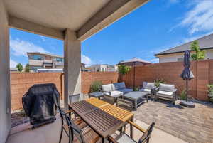 Fenced backyard featuring a patio area, outdoor dining area, outdoor lounge area, and area for grilling