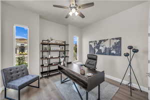 Office area with wood finished floors and ceiling fan