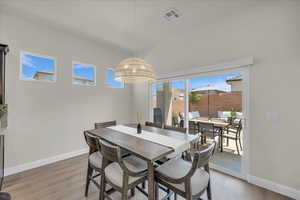 Dining space with baseboards and light wood-type flooring