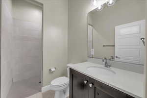 Bathroom with vanity, a stall shower, and light tile patterned flooring