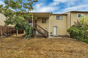 Rear view of house featuring stairway and a patio