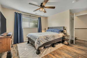 Bedroom with light wood finished floors and ceiling fan