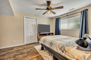 Bedroom with wood finished floors, a closet, and ceiling fan