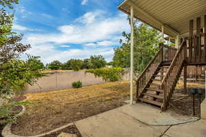 Fenced backyard with stairs