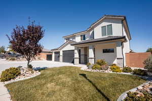 View of front of house with a garage, driveway, brick siding, a tile roof, and covered porch