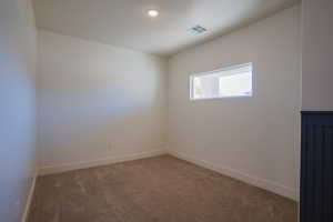 Carpeted empty room featuring baseboards