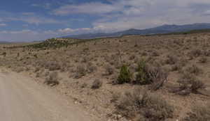 View of mountain backdrop with a desert landscape and rural landscape