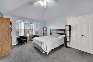 Bedroom featuring lofted ceiling, carpet, and ceiling fan