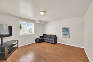 Living area with a textured ceiling and wood finished floors