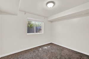 Spare room featuring carpet flooring and a textured ceiling