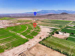 Aerial view of property's location featuring a mountainous background and rural landscape
