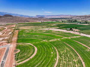 Aerial view of property's location featuring a mountain backdrop and rural landscape