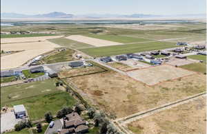 Overview of rural landscape with property parcel outlined and a mountainous background