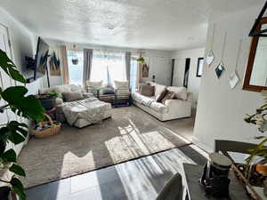 Living area featuring a textured ceiling and tile patterned flooring