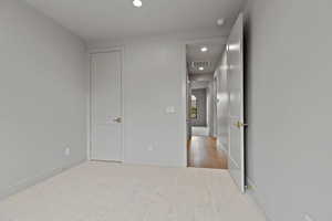 Unfurnished room with recessed lighting and baseboards