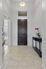 Foyer featuring light tile patterned flooring
