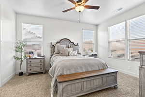 Bedroom with light carpet and a ceiling fan