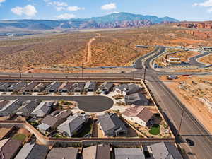 Aerial view of property's location with nearby suburban area and mountains