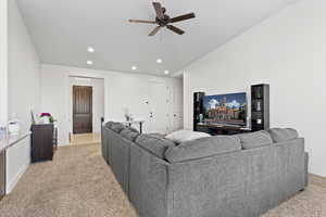 Living area with light colored carpet, recessed lighting, and ceiling fan