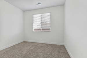 Carpeted empty room with baseboards