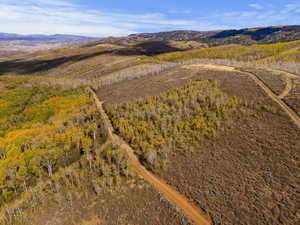 Aerial overview of property's location featuring a mountainous background