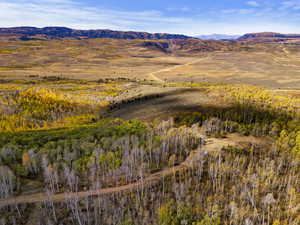 Aerial view of property and surrounding area with a mountainous background