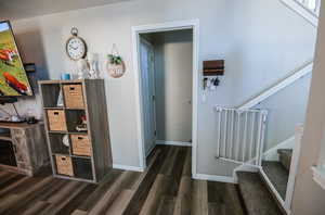 Hall featuring stairway and dark wood-type flooring