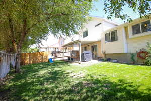 Back of house with a patio area and a fenced backyard