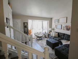 Living area featuring wood finished floors and stairway
