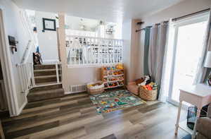 Game room with wood finished floors and baseboards