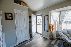 Entryway featuring baseboards and dark wood finished floors