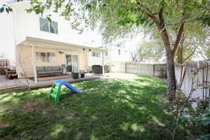 Back of house featuring a deck, a fenced backyard, and an outdoor living space