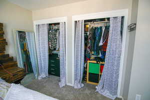 Bedroom featuring two closets and carpet floors