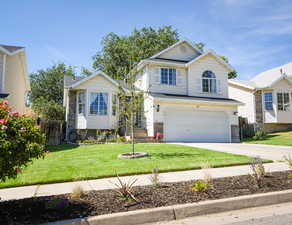 Traditional-style house featuring driveway and a garage