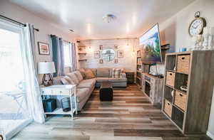 Living area with wooden walls and wood finished floors