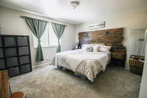 Bedroom featuring carpet floors and baseboards