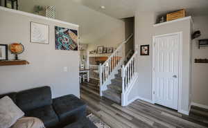 Foyer entrance featuring stairway and dark wood-style flooring