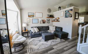 Living room with vaulted ceiling and wood finished floors