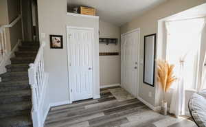 Foyer featuring stairs and light wood-type flooring