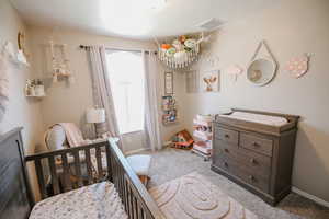 Bedroom with carpet floors and baseboards