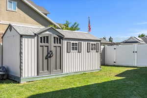 View of shed featuring a gate
