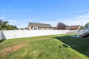 Fenced backyard with a residential view and a patio