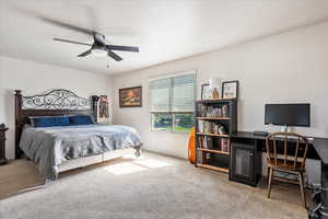 Bedroom with carpet flooring, a desk, and ceiling fan